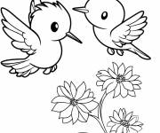 Coloriage Deux petits colibris planant au-dessus d'une fleur