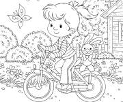 Coloriage et dessins gratuit Fillette conduit son v&eacute;lo dans la nature à imprimer