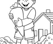 Coloriage Un enfant tenant une grosse carotte