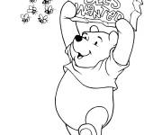 Coloriage Winnie avec un signe et les abeilles sont la