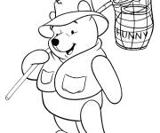 Coloriage Winnie l'ourson attrape le pot de miel