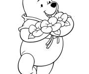 Coloriage Winnie ourson avec un bouquet de fleurs