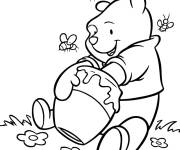 Coloriage Winnie ourson mangeant du miel