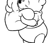 Coloriage Winnie ourson tenant un coussin