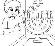 Coloriage Le jeune gar&ccedil;on allume la bougie pour hanoucca