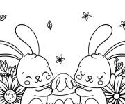 Coloriage et dessins gratuit Deux lapins serrant dans leurs bras un &oelig;uf de P&acirc;ques à imprimer