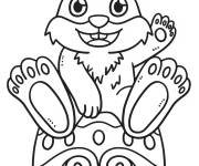 Coloriage Lapin de P&acirc;ques  assis sur un oeuf paign&eacute;