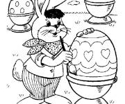 Coloriage Lapin de P&acirc;ques en mission de d&eacute;corer les oeufs en chocolat