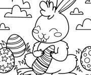Coloriage et dessins gratuit Lapin de P&acirc;ques tenant une carotte GS à imprimer