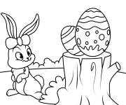Coloriage Lapin et oeufs de P&acirc;ques plac&eacute;s sur un tronc
