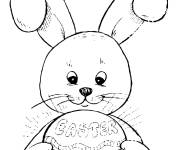 Coloriage Lapin qui tien un &oelig;uf de P&acirc;ques qui brille