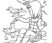 Coloriage Une fille mignonne nourrit les oies