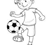 Coloriage Le petit footballeur dribble au ballon