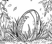Coloriage Ballon de rugby parmi les feuilles